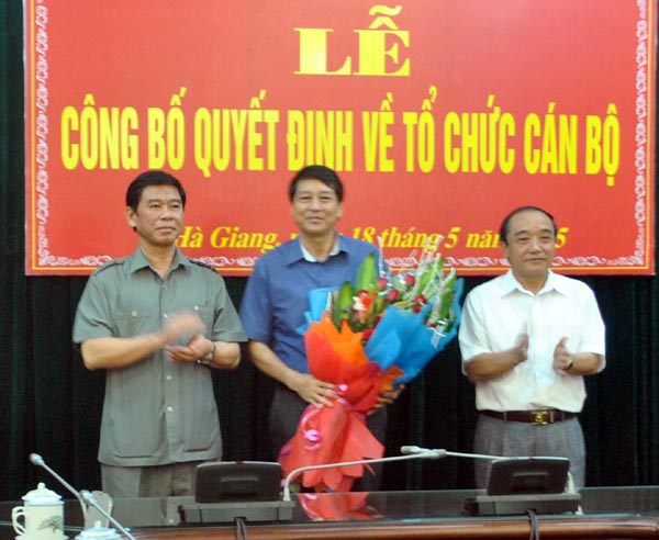 Đồng chí Vương Mí Vàng và đồng chí Đàm Văn Bông trao quyết định, tặng hoa chúc mừng đồng chí Hoàng Quyết Chiến.