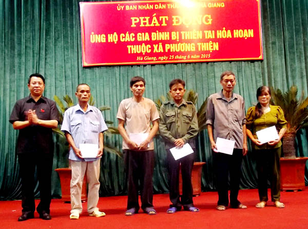 Đồng chí Trần Mạnh Lợi, Ủy viên BTV Tỉnh ủy, Bí thư Thành ủy TP Hà Giang trao tiền hỗ trợ cho các  hộ các gia đình bị hỏa hoạn.