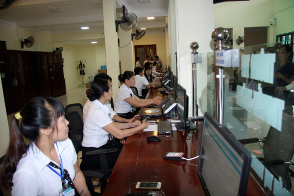 Cán bộ nhân viên Trung tâm hành chính công thực hiện giao dịch với khách hàng.