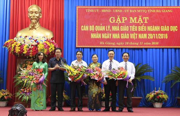 Các đồng chí: Thào Hồng Sơn, Phó Bí thư Thường trực Tỉnh ủy, Chủ tịch HĐND tỉnh; Nguyễn Văn Sơn, Phó Bí thư Tỉnh ủy, Chủ tịch UBND tỉnh tặng hoa chúc mừng cán bộ, giáo viên ngành Giáo dục.