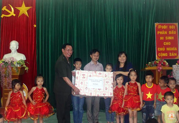 Đồng chí Ly Mí Lử tặng quà cho các cháu thiếu nhi trường Tiểu học và Mầm non xã Nậm Khoà.