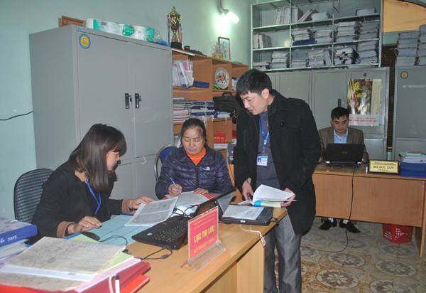 Cán bộ Văn phòng đăng ký đất đai - Chi nhánh huyện Đồng Văn hướng dẫn người dân đăng ký giao dịch đảm bảo bằng quyền sử dụng đất.