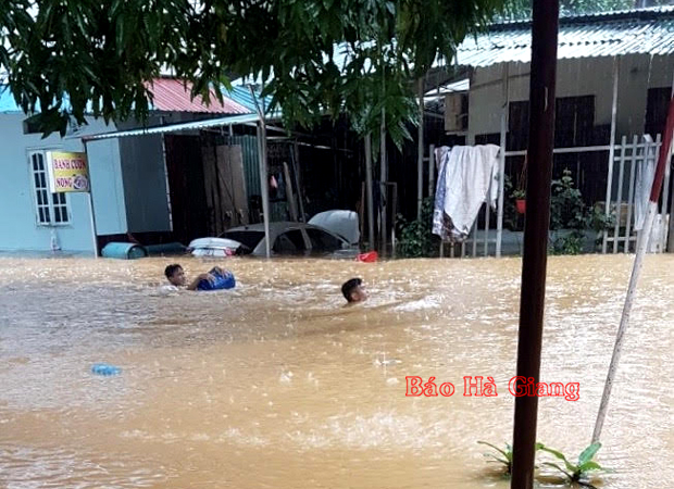 Người dân tổ 14 phường Trần Phú (TPHG) bơi trong nước lũ để di chuyển đồ đạc. ảnh: Quỳnh Hương