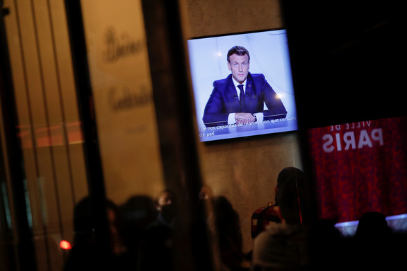 Người dân Pháp theo dõi bài phát biểu của Tổng thống Macron ngày 28-10 - Ảnh: REUTERS