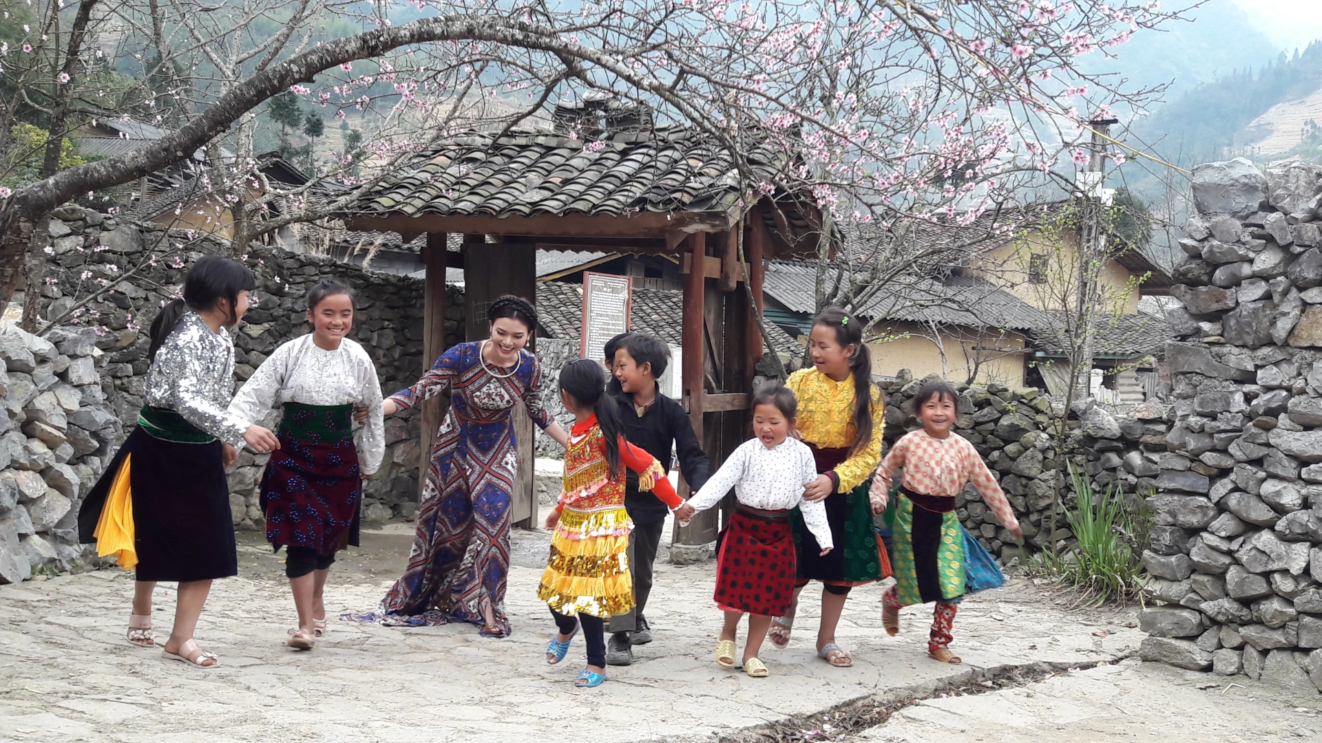 Tourists immerse themselves in spring festivities, sharing joy with highland children.