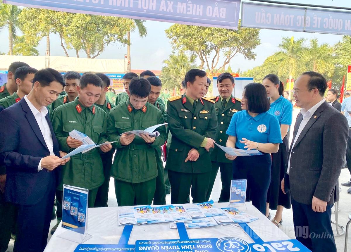 Các đại biểu và quân nhân tại gian hàng tư vấn chính sách bảo hiểm xã hội.