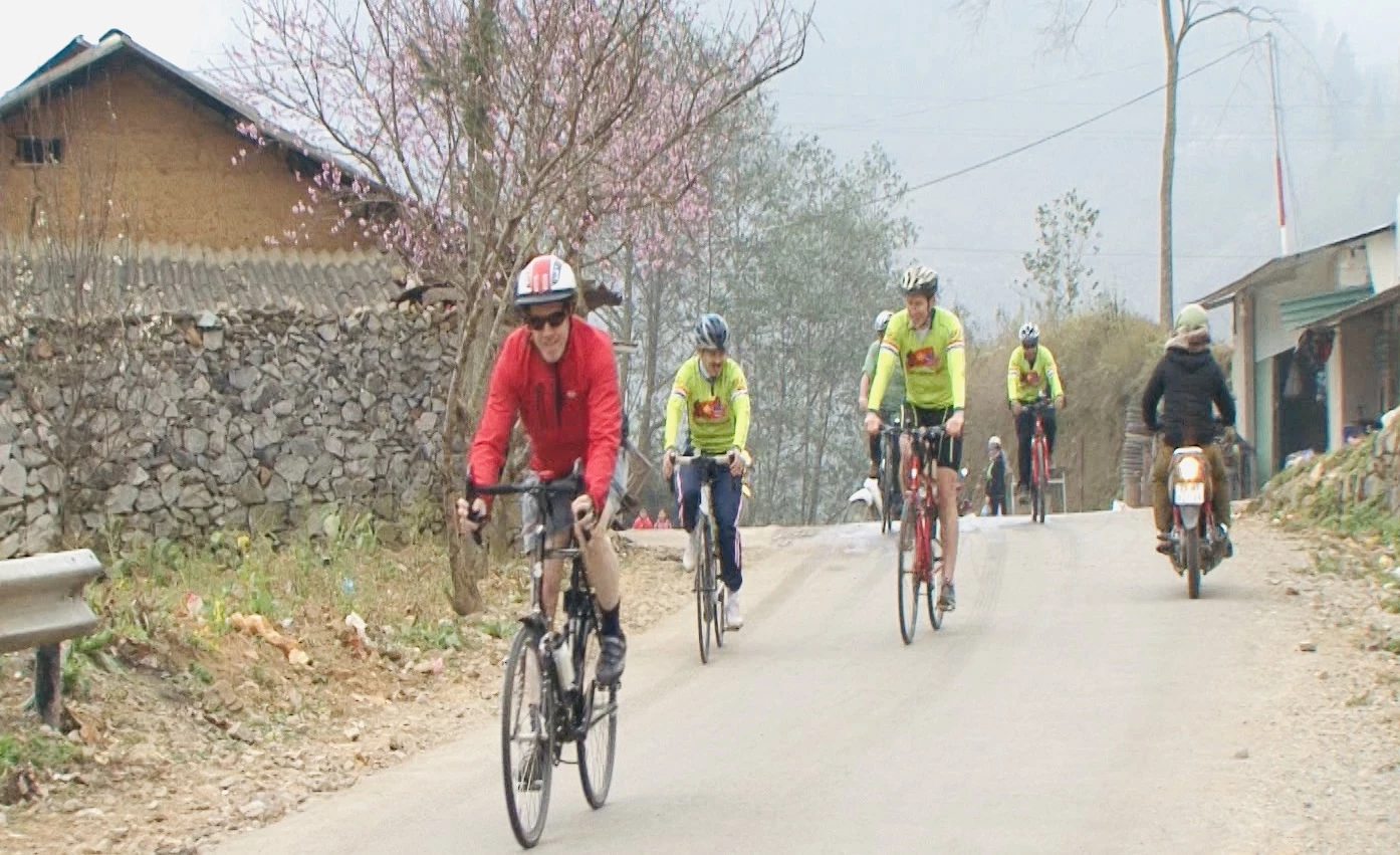 Ted Osius (first), former U.S. Ambassador to Vietnam, and a diplomatic delegation cycle along the Happiness Road.