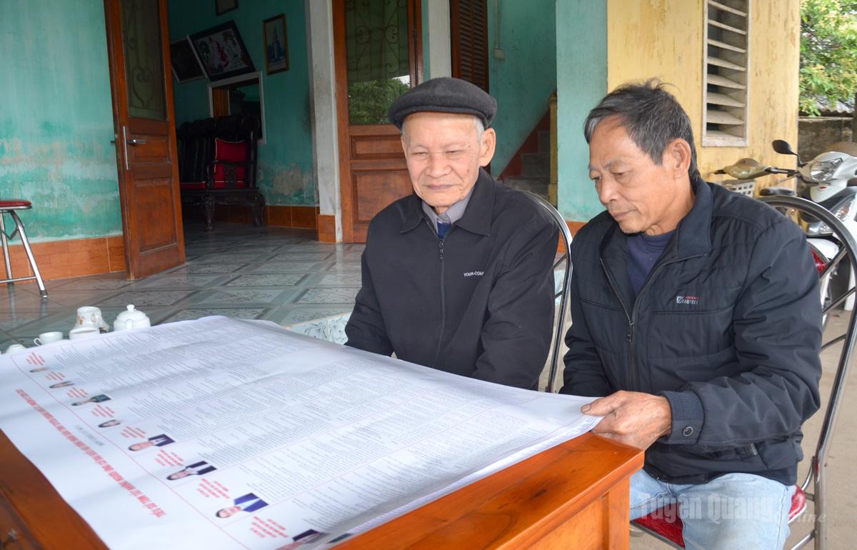 Ông Đào Trọng Kha (đội mũ) 89 tuổi, có 65 năm tuổi Đảng trao đổi với ông Tống Văn Đồng, Bí thư Chi bộ, Tổ trưởng tổ dân phố Tân Hà 2, phường Minh Xuân về các ứng cử viên đại biểu Quốc hội và HĐND các cấp.
