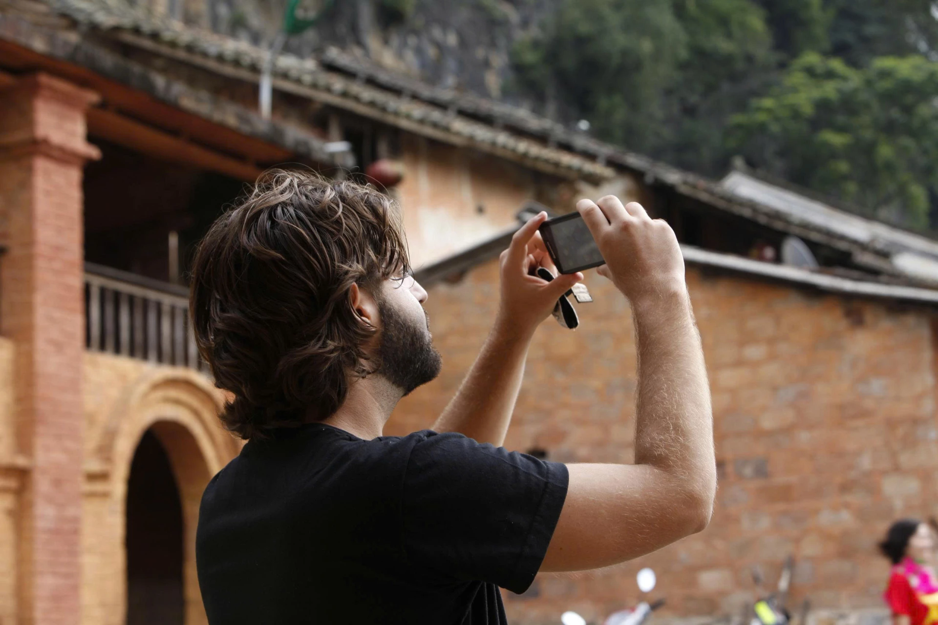 A foreigner takes photos amid the beauty of Dong Van Karst Plateau.