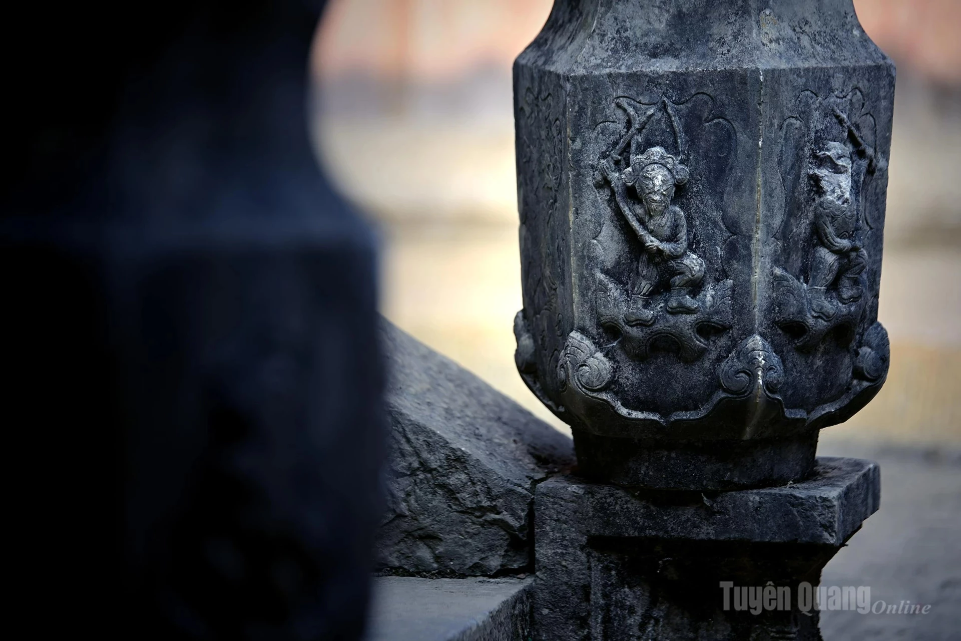 The decorative details are intricately crafted, with stone columns carved with opium flower motifs.