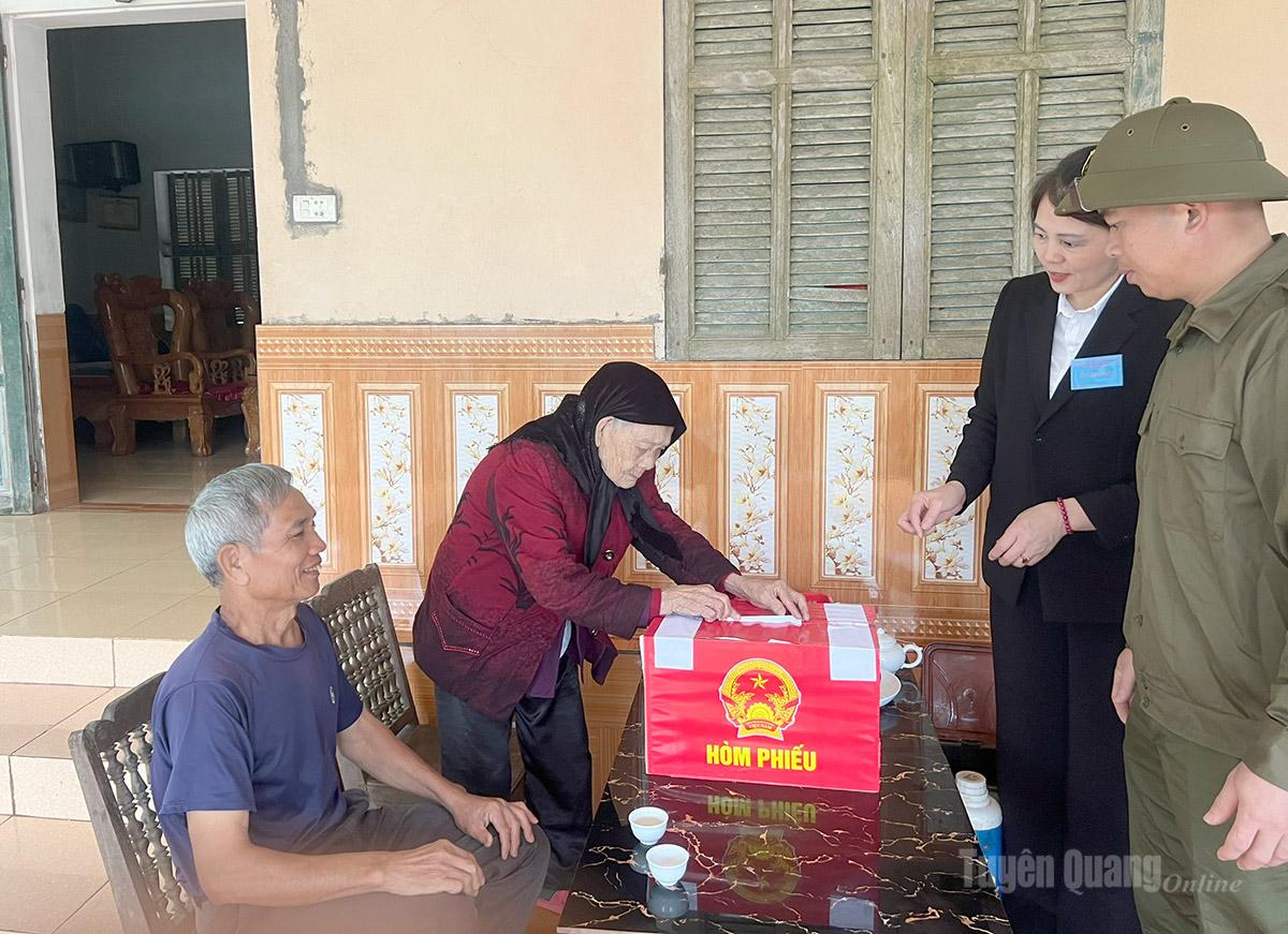 Cử tri Trịnh Thị Phượng, 102 tuổi, Mẹ liệt sĩ Đinh Đức Nhuận, thôn Vắt Cày, xã Lực Hành bỏ phiếu tại nhà bằng hòm phiếu phụ. Ảnh: Lý Thu