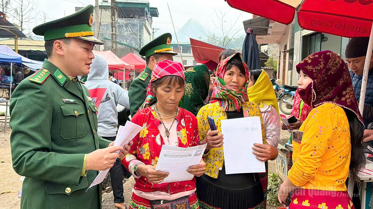 Cán bộ Đồn Biên phòng Sơn Vĩ tuyên truyền Luật Bầu cử tại chợ phiên.
