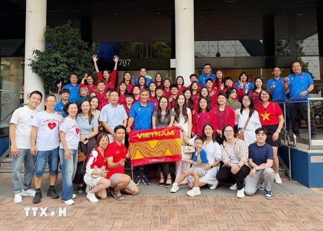 The Viet Nam women’s national football team takes a commemorative photo with overseas Vietnamese, fans, and supporters. (VNA)