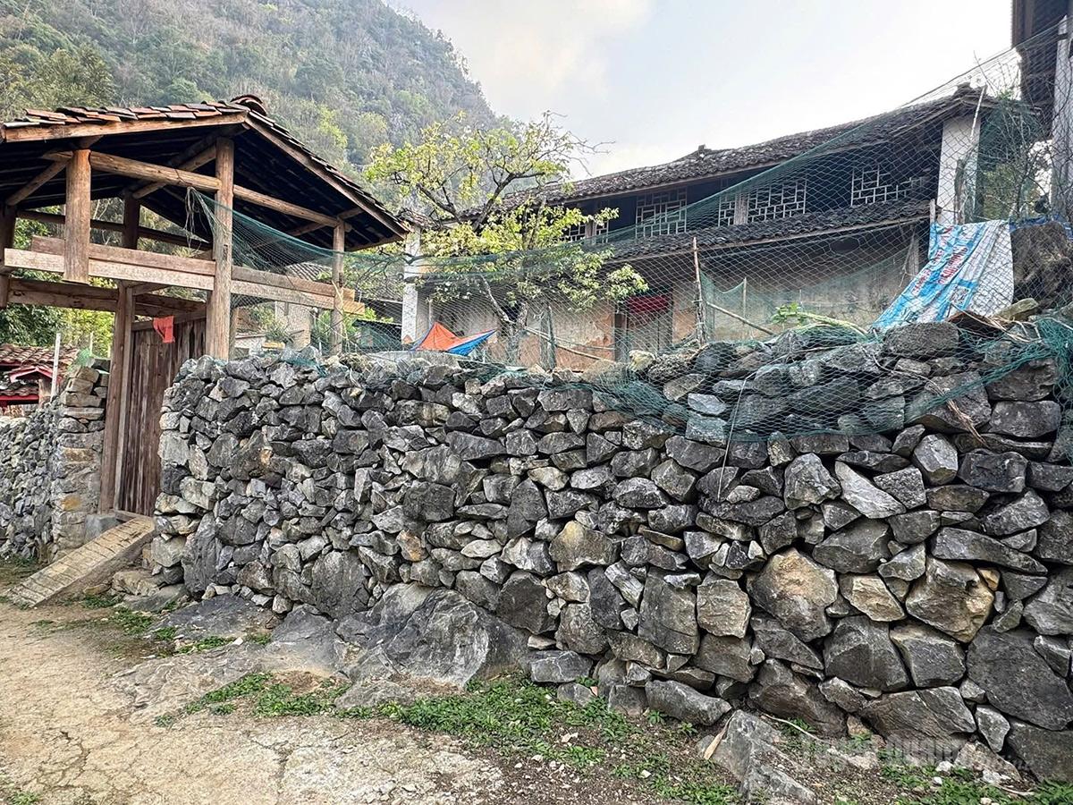 Sturdy stone fences surround the homes of the Hmong people.