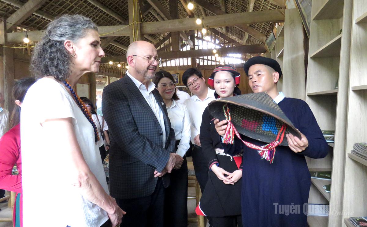 Người dân thôn Khun giới thiệu cách làm và ý nghĩa của nón lá hai mê truyền thống của dân tộc Tày với đoàn công tác Đại sứ quán Thụy Sĩ tại Việt Nam.