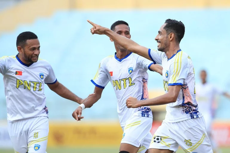 Timor-Leste players jubilantly celebrate an equalising goal against Cambodia.
