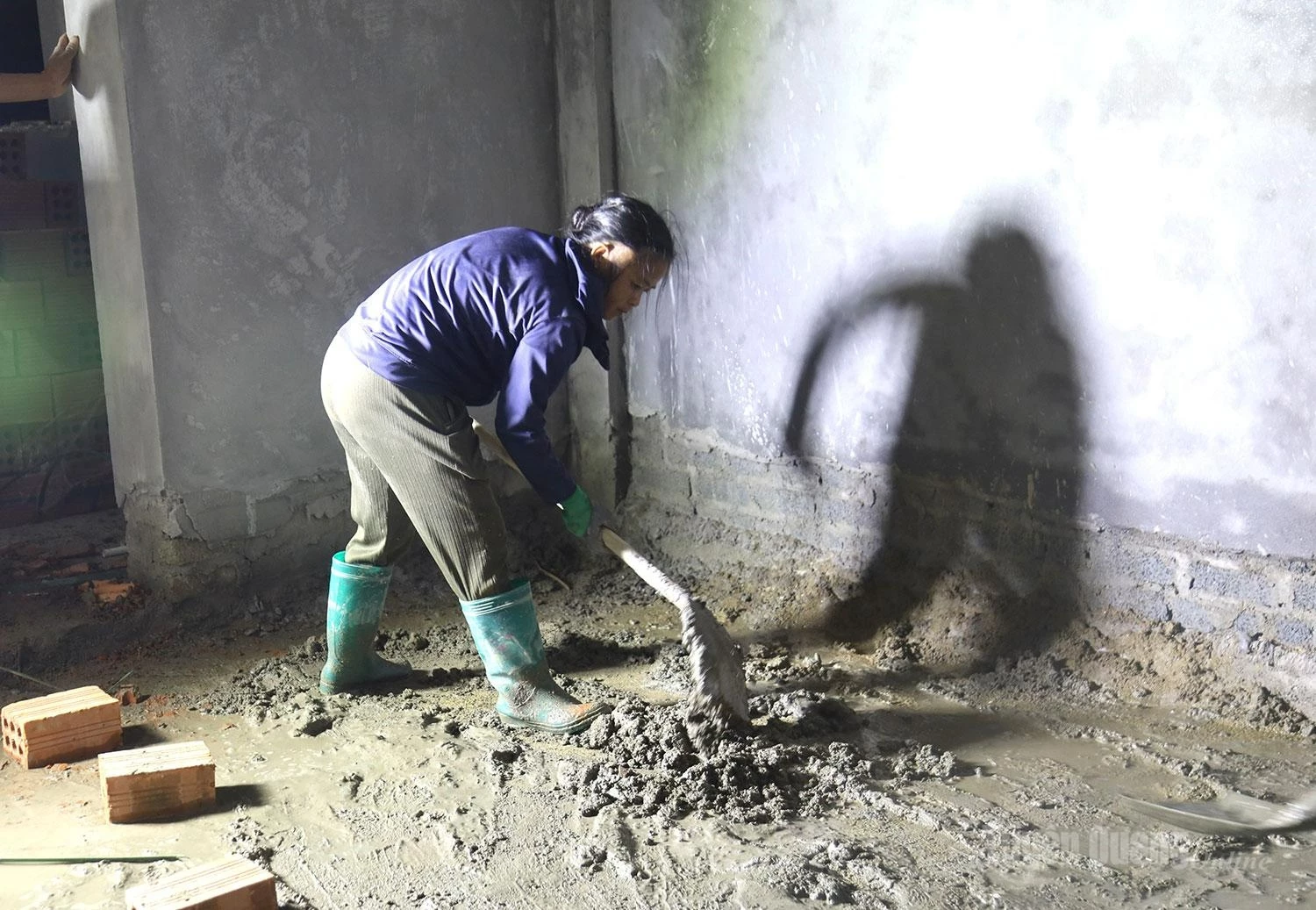 Beneath the construction lights, sweat soaks through the workers shirts as their silhouettes stretch across the walls. Quietly, they continue laying each section of flooring, helping bring the new border-area school closer to reality.