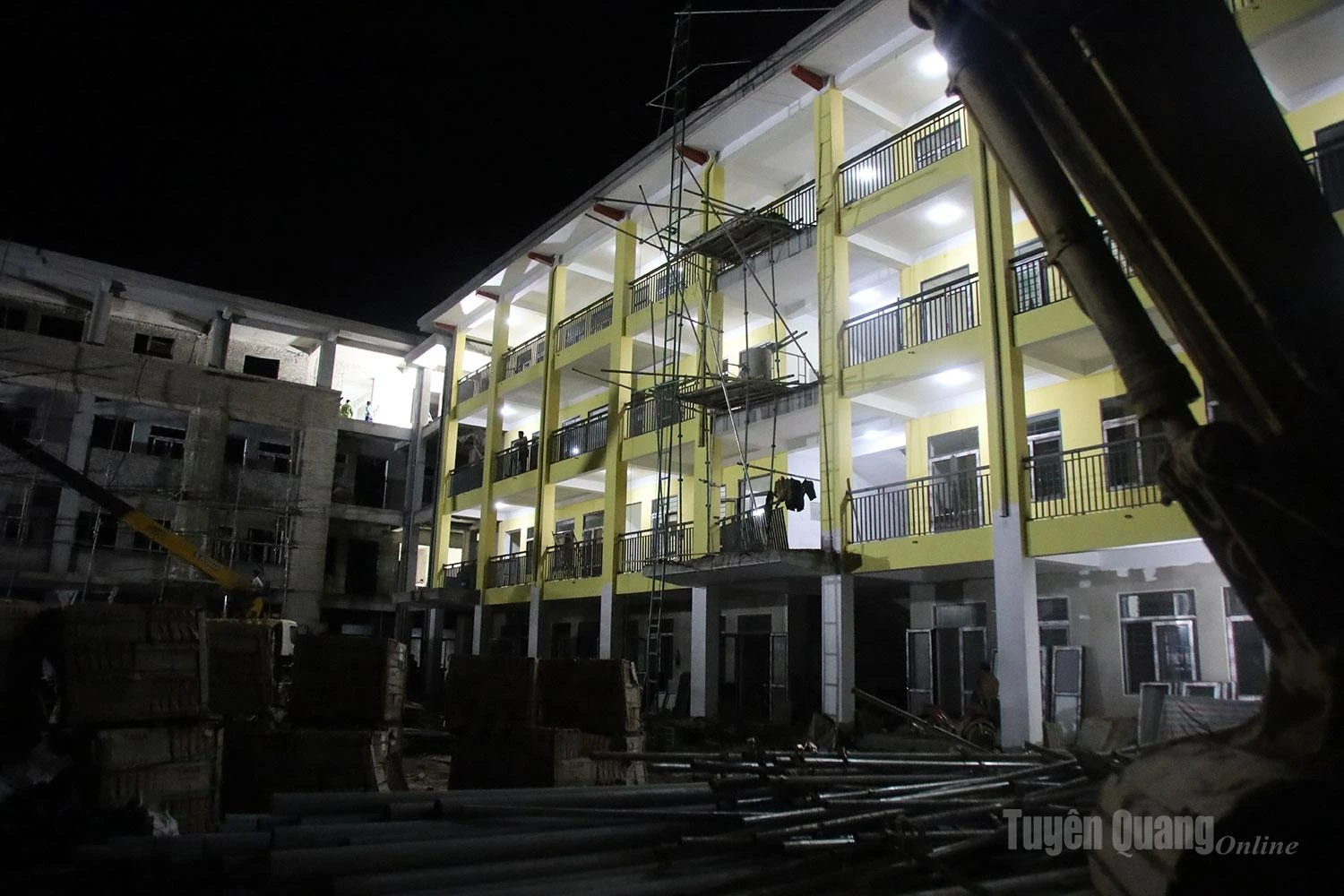 As darkness descends, the construction site of the Pa Vay Su Inter-level Boarding School remains brightly lit as work crews begin their night shift.