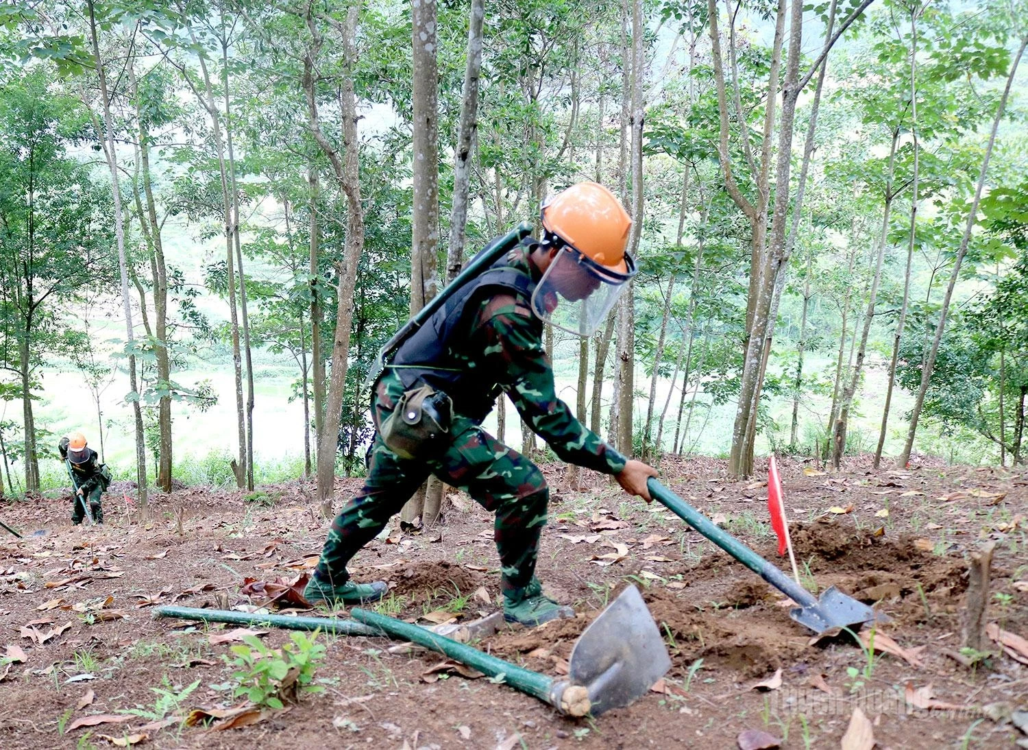 Once a target area is identified and marked, officers and soldiers patiently carry out manual excavation to reach the unexploded ordnance.