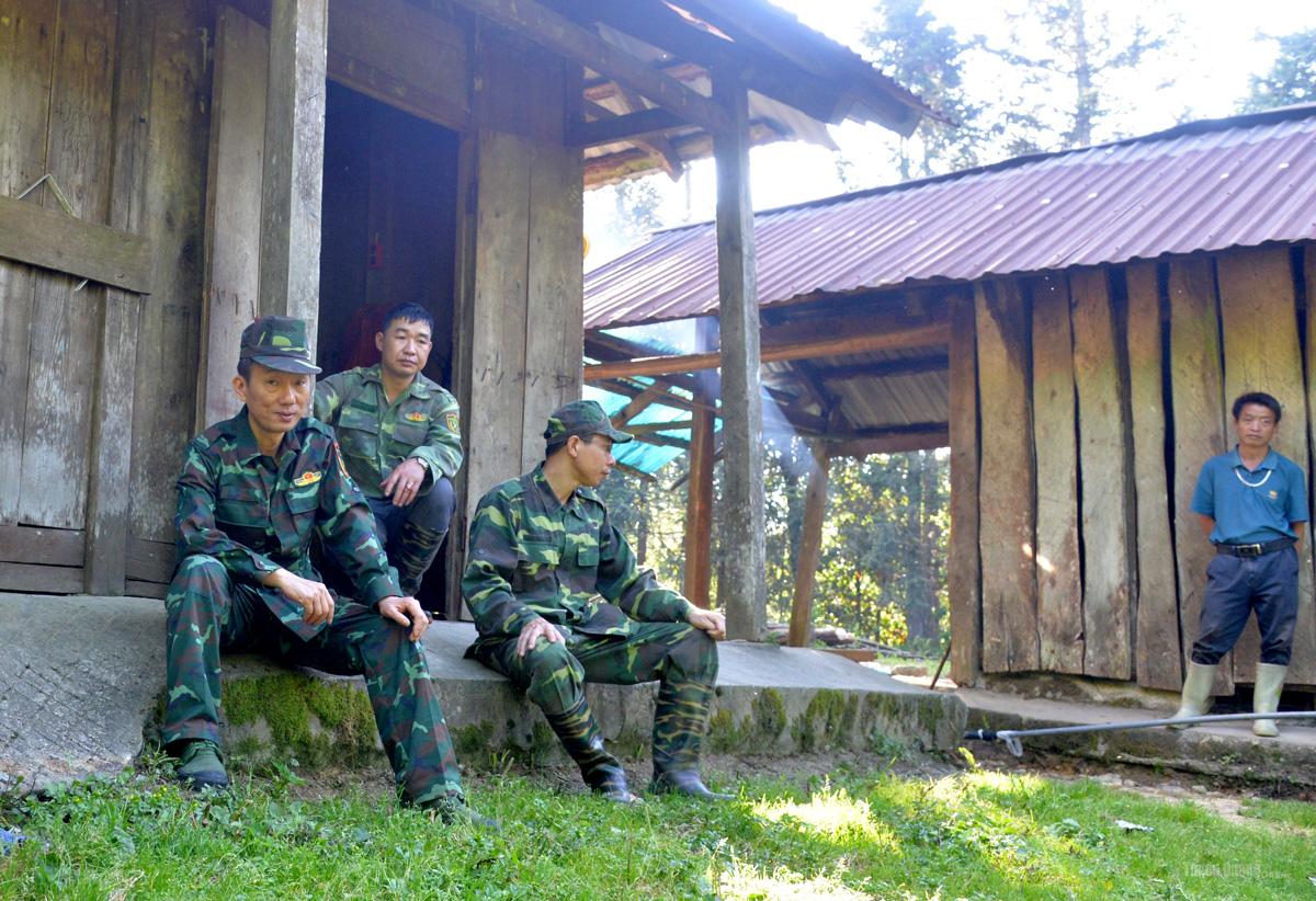 A rare moment of rest for the patrol team after a long day climbing through the forest.