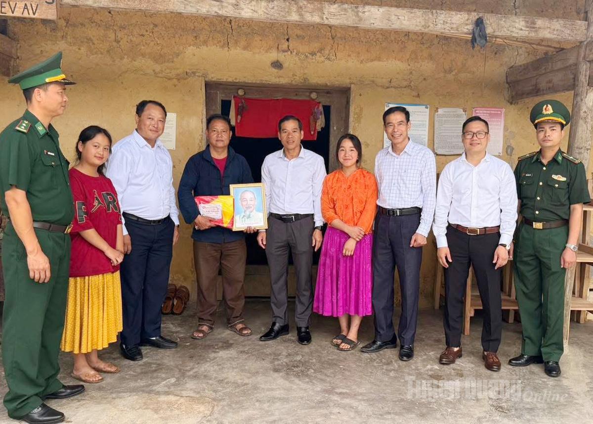 Lãnh đạo xã Lũng Cú trao tặng cờ Tổ quốc và ảnh Bác Hồ cho người dân khu vực biên giới.