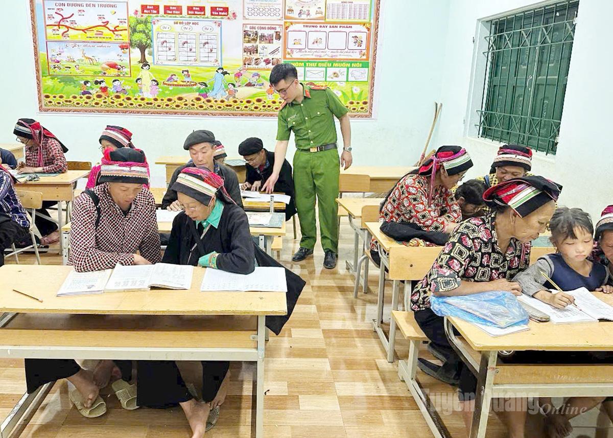 Thượng úy Phan Mạnh Hùng, cán bộ công an xã Bạch Đích tham gia trợ giảng lớp xóa mù chữ vào các buổi tối.