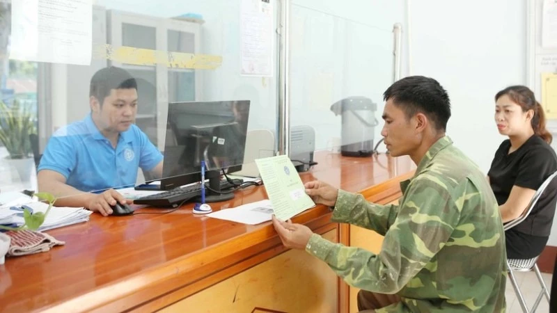Hướng dẫn người dân sử dụng sổ Bảo hiểm xã hội. Ảnh minh họa.
