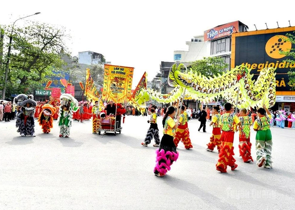 Unicorn-lion-dragon dancers join the procession honoring the Mother Goddess at Ha Temple, Thuong Temple and Y La Temple Festival.