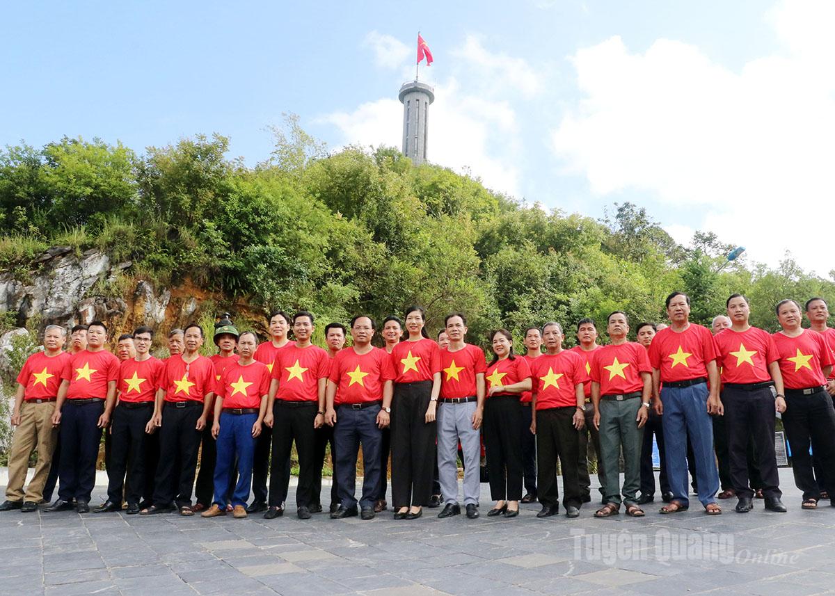 People dressed in bright red shirts adorned with the yellow star gathered to capture meaningful moments under the national flag.