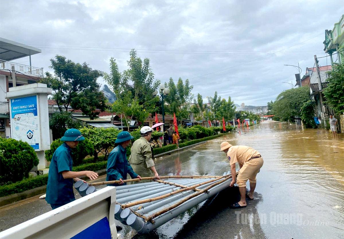 Tổ công tác Phòng Cảnh sát giao thông Công an tỉnh hỗ trợ người dân di chuyển tại các khu vực ngập úng xã Nà Hang. Ảnh Phạm Hoan