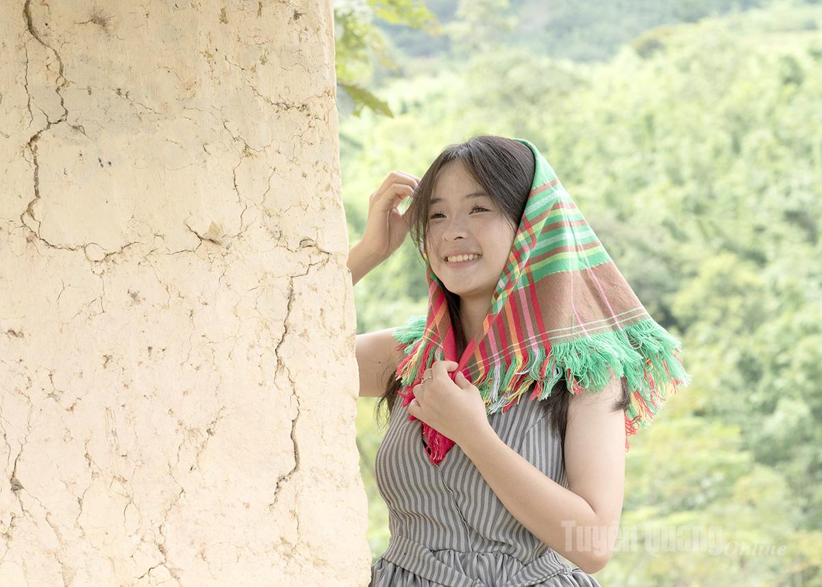 Thiếu nữ Mông e ấp trang điểm bên góc nhà trình tường.