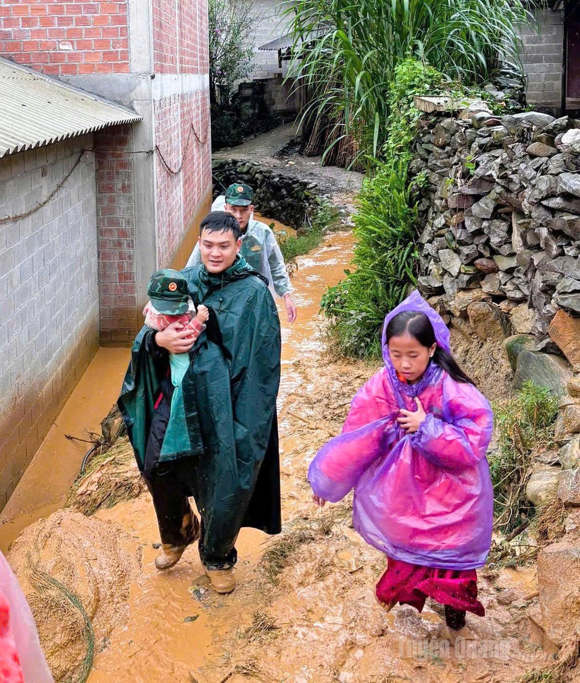 Cán bộ, chiến sỹ Đồn Biên phòng Lũng Cú sơ tán người dân thôn Má Lầu A, xã Lũng Cú đến nơi an toàn. Ảnh: Hạ Hòa