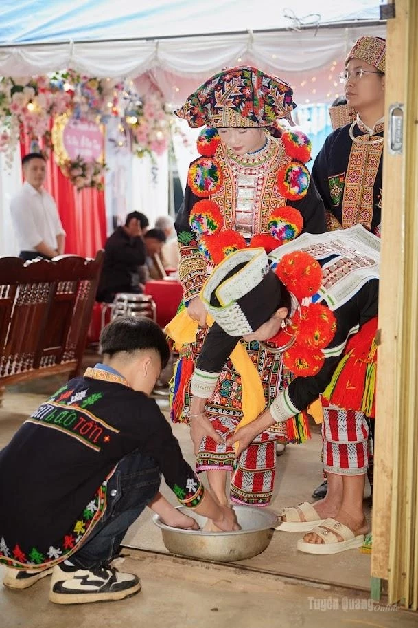 A Red Dao bride takes part in the traditional foot-washing ritual.