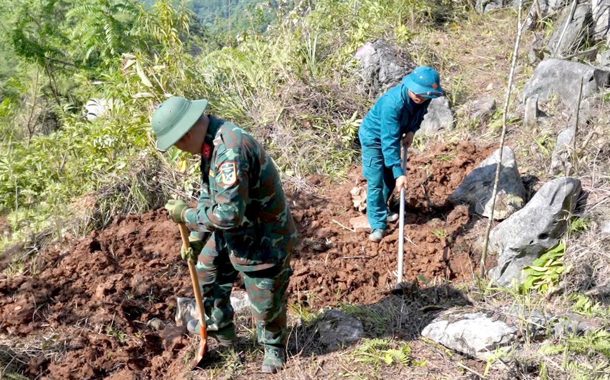 Cán bộ Đội Tìm kiếm, quy tập hài cốt liệt sĩ và dân quân tham gia tìm kiếm hài cốt liệt sĩ tại núi Bạc.
