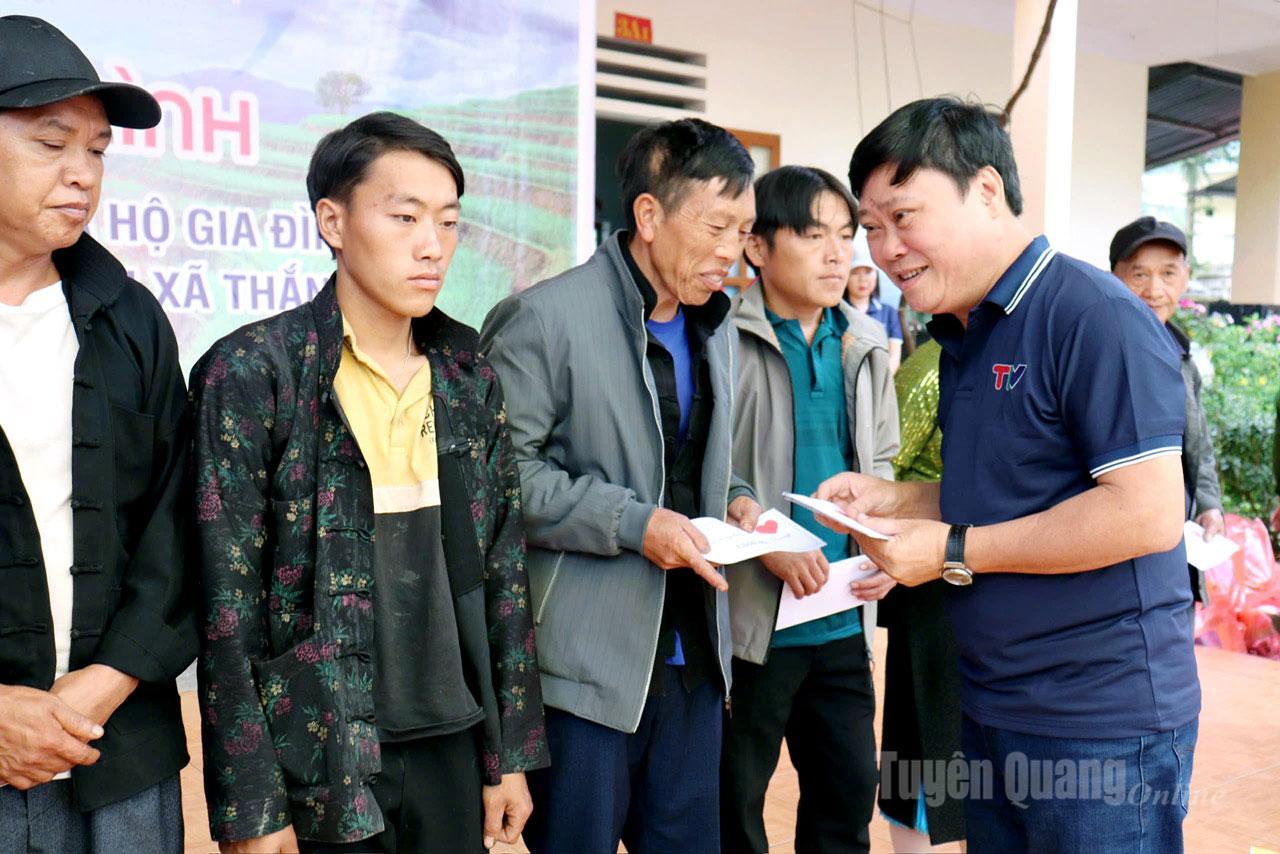 Đồng chí Mai Đức Thông, Ủy viên BCH Đảng bộ tỉnh, Tổng biên tập Báo và phát thanh truyền hình Tuyên Quang tặng quà của nhà tài trợ cho các hộ dân.