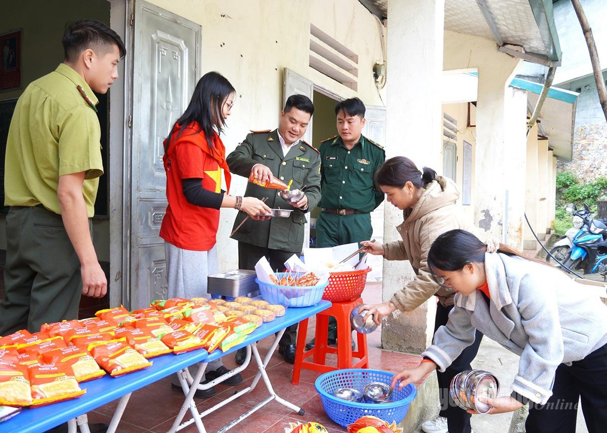 Thành viên đoàn chuẩn bị bữa ăn tặng học sinh tại điểm trường thôn Cò Súng, xã Sơn Vĩ.