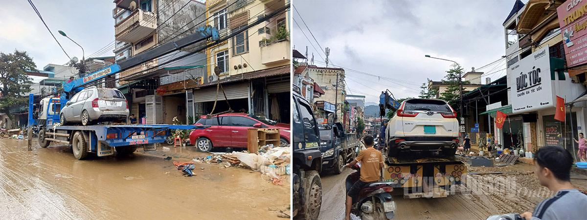 Lực lượng cứu hộ giao thông nỗ lực di chuyển các phương tiện ô tô bị ngập úng ở phường Hà Giang 2. Ảnh: Văn Long
