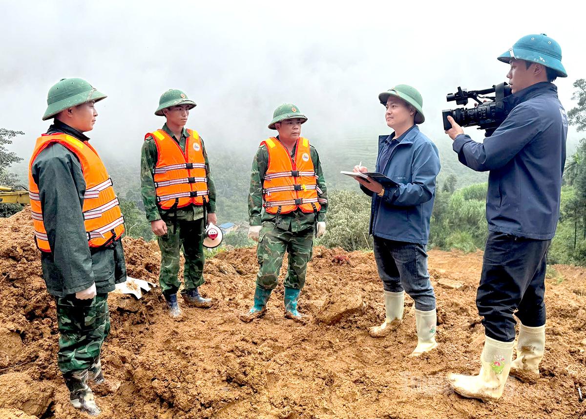 Phóng viên Báo và Phát thanh, truyền hình Tuyên Quang tác nghiệp tại hiện trường vụ sạt lở đất thôn Má Lầu A, xã Lũng Cú. Ảnh: Trần Kế