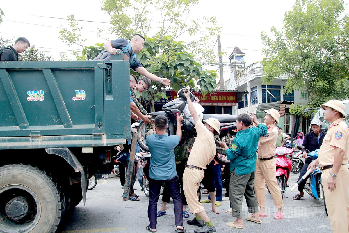 Lực lượng Cảnh sát giao thông tỉnh Tuyên Quang hỗ trợ người dân đi qua đoạn ngập lụt trên Quốc lộ 2, địa phận xã Tân Quang. Ảnh CTV Chí Cường