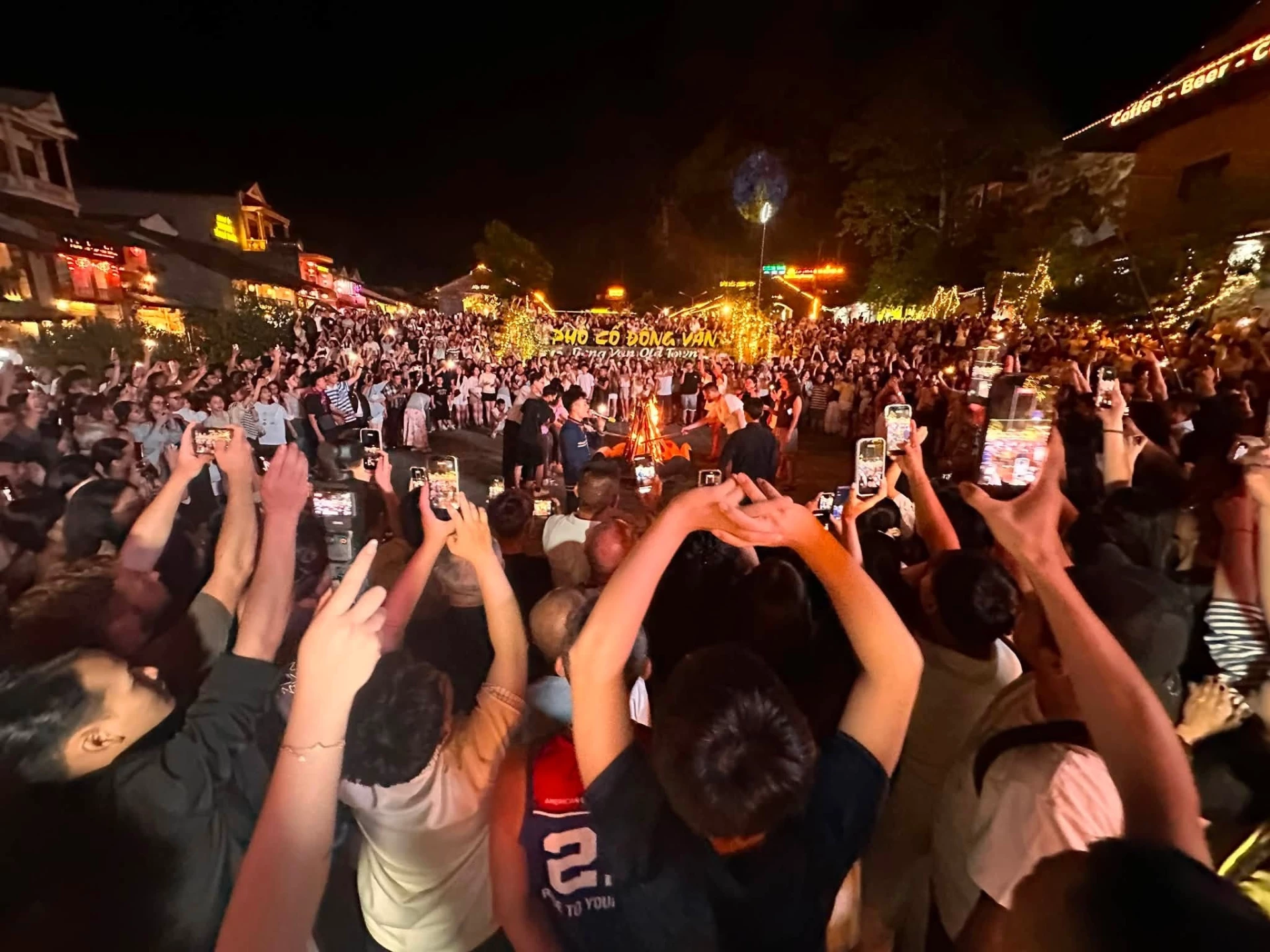 Under the twinkling lights illuminating rows of old houses, the central courtyard becomes a cultural meeting place where people come together without barriers.