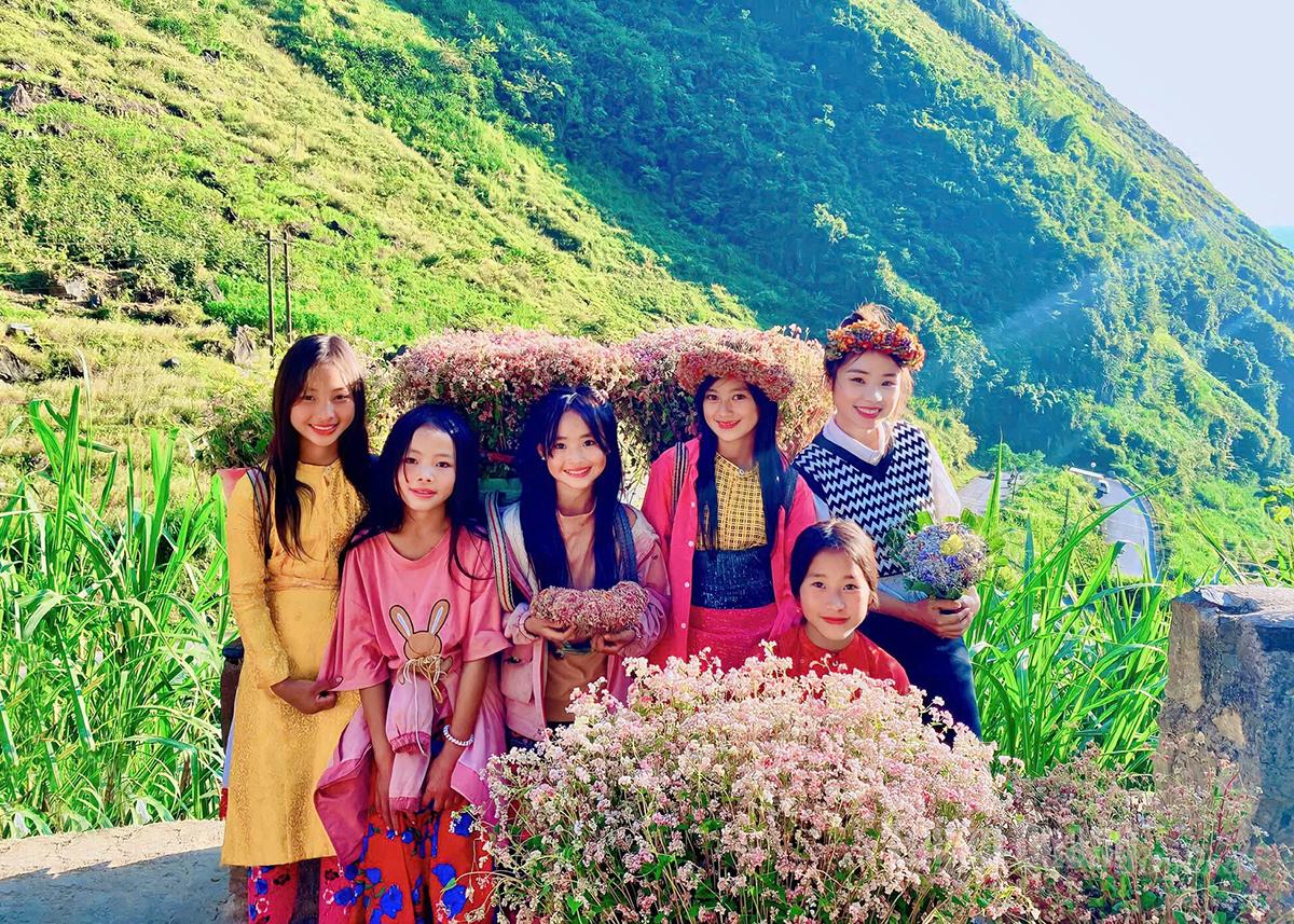 Highland children posing with the vibrant blooms.