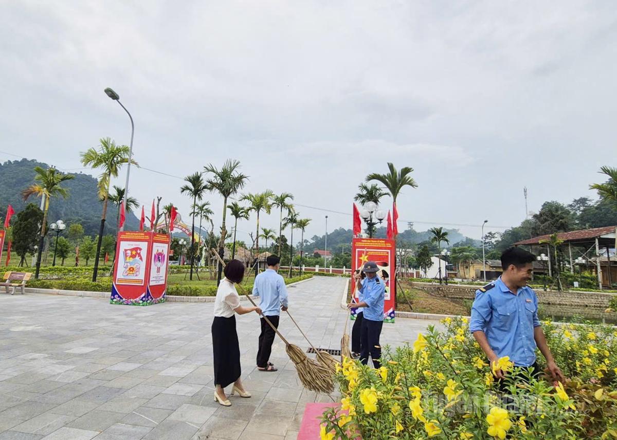 Staff members of the ATK Tan Trao Museum clean the museum’s surrounding landscape.