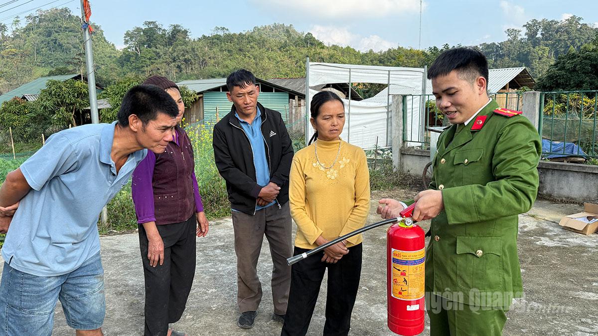 Công an xã Yên Hoa hướng dẫn người dân sử dụng bình chữa cháy xách tay.