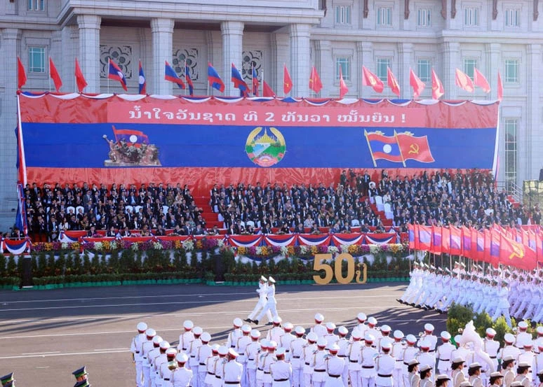 A military parade and march held to celebrate the 50th National Day of the Lao People’s Democratic Republic. (Photo: VNA)