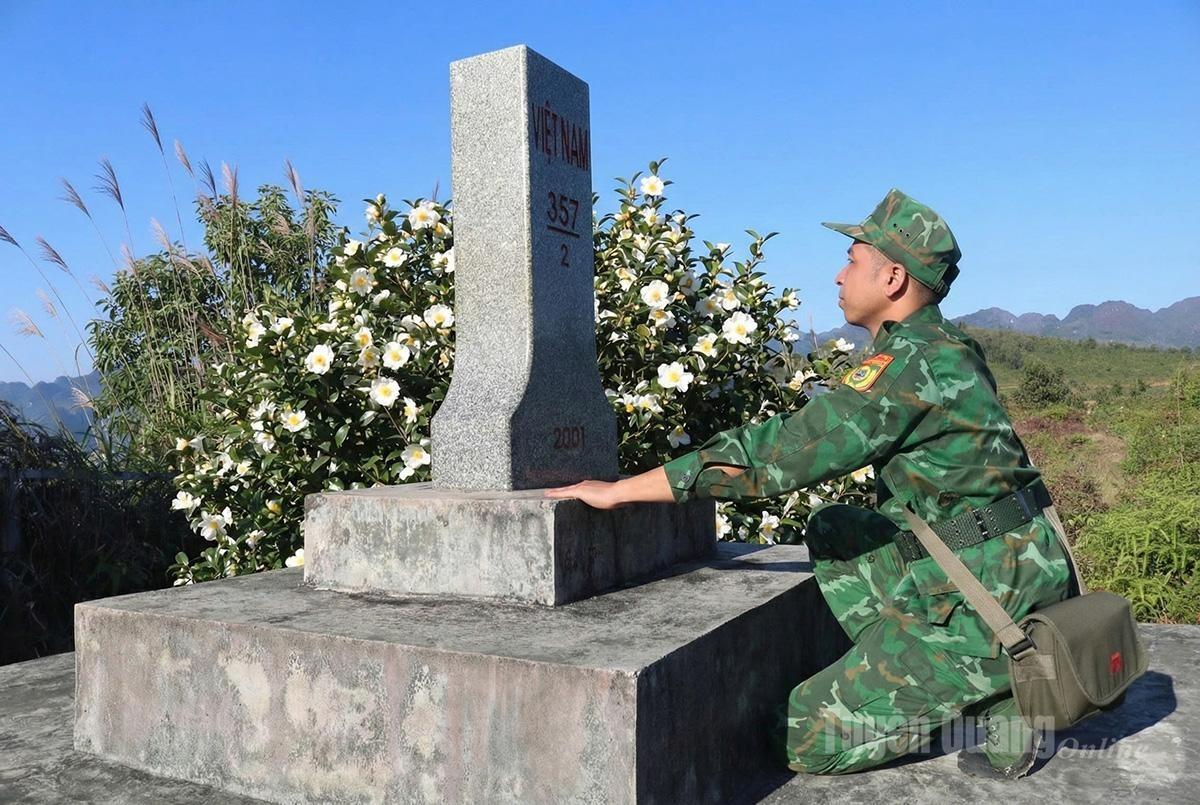 Officers of Bach Dich Border Guard Station inspect sovereignty markers along the border line.