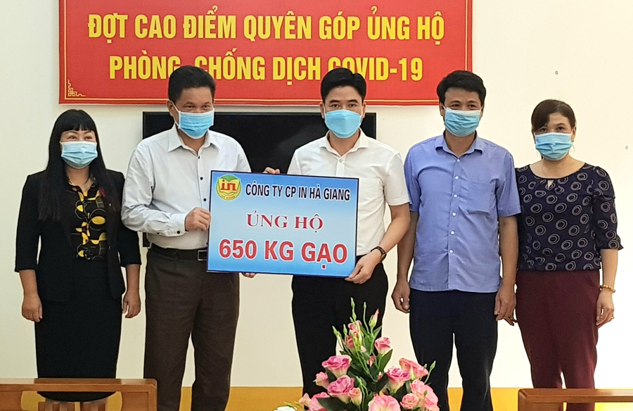 Chủ tịch Ủy ban MTTQ tỉnh Vàng Seo Cón tiếp nhận quà ủng hộ từ lãnh đạo Công ty cổ phần In Hà Giang.